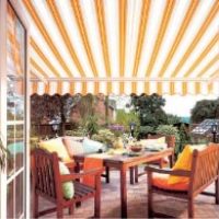 Yellow and white awnings above garden doors on a summer's day