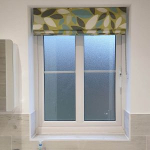 green patterned Roman blinds