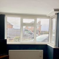 white Venetian blinds with navy blue walls