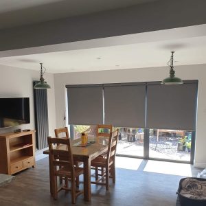 grey electric roller blinds on bi-fold doors