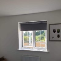 grey roller blind on open window
