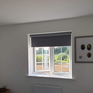 grey roller blind on open window