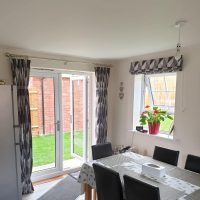 geometric black and white Roman blinds with matching curtains