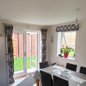 geometric black and white Roman blinds with matching curtains