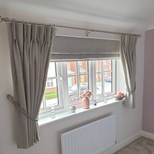 pale grey Roman blinds with matching curtains