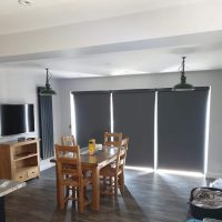 closed grey electric roller blinds on bi-fold doors