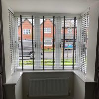 white Venetian blinds with tapes