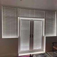 Venetian blinds on door and surrounding windows