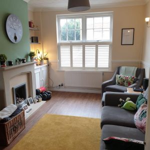 open cafe style shutters in modern living room