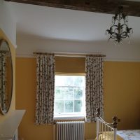 yellow Roman blinds in bedroom