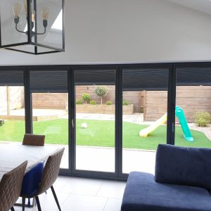 dark bi-fold door blinds in modern home