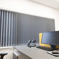 grey vertical blinds in an office