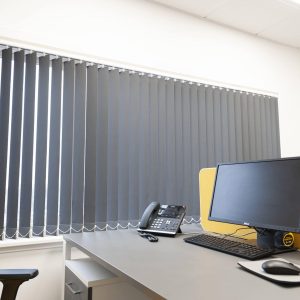 grey vertical blinds in an office