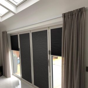 grey pleated blinds on bifold doors