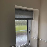 grey roller blind in bathroom