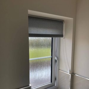grey roller blind in bathroom