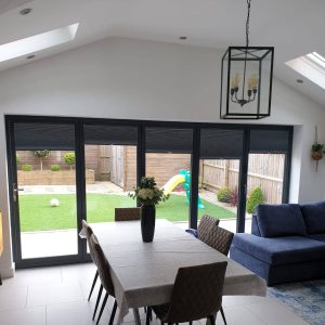bi-fold door blinds in front of dining table in modern home