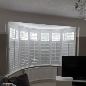white plantation shutters on a large bay window