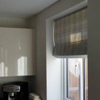 checked Roman blinds in a kitchen