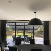 modern home looking out to garden awning