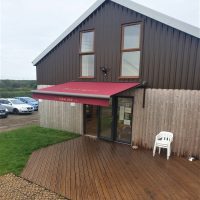 Bespoke awning with branded signage in Northamptonshire by Fraser James Blinds