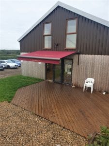 Bespoke awning with branded signage in Northamptonshire by Fraser James Blinds