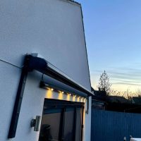 Electric Awning with lighting above screen door to at rear of property (side angle)