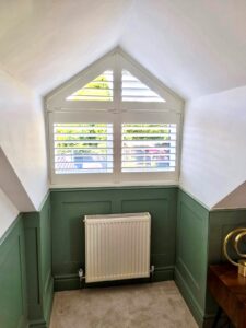 Shaped Shutters, triangle window with a half green painted wall